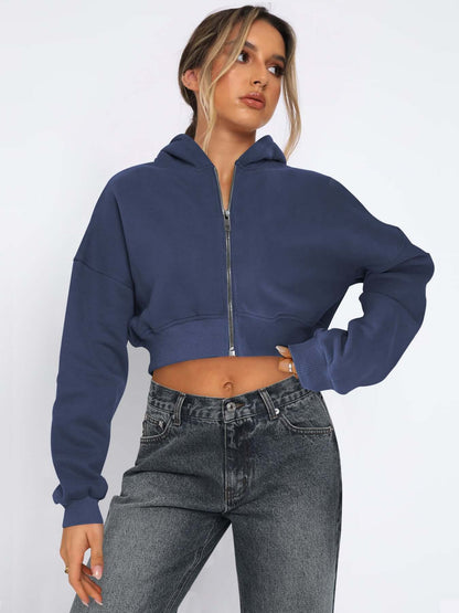 Casual street style model in a cropped navy fleece zipper hoodie, paired with high-waisted jeans, perfect for spring and fall.